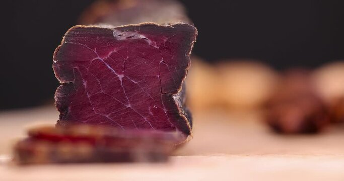 focus on dried red beef meat on the kitchen table, red piece of beef jerky during cooking