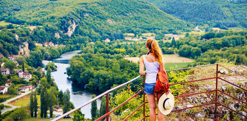 Fototapeta premium Woman enjoying panoramic view of Lot valley in France- Occitanie