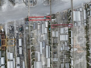 Aerial view of industrial warehouse facility with goods being prepared for transport. Overhead crane for moving products.