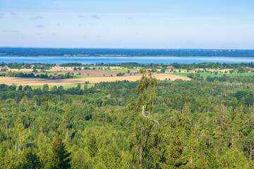 Fototapeta na wymiar View at a forest and a beautiful countryside with a lake