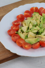 Dish with avocado and cherry tomato