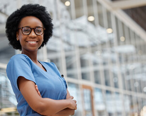 Nurse, arms crossed and portrait of black woman in hospital for medical, support and expert....