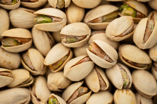 Salted Pistachios for Beer, Macro, Spin. Isolated Background of a Beer Snack of Salted Pistachio Nuts. Healthy Delicious Pistachios. Salted roasted pistachio macro	
