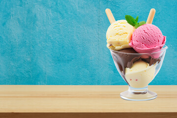 Sweet Indulgence on a Table- Ice Cream in a Bowl by the Blue Wall
