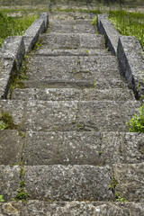 Picturesque view of stone steps of stairs in park. Old stone staircase leading down. Upward movement. Selective focus.
