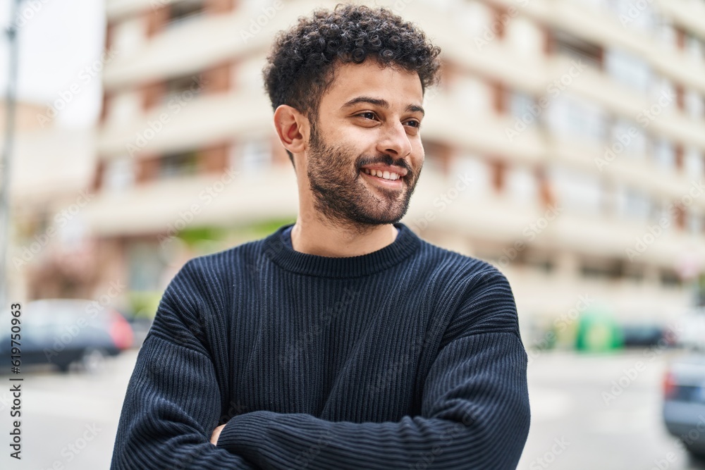 Sticker Young arab man smiling confident standing with arms crossed gesture at street