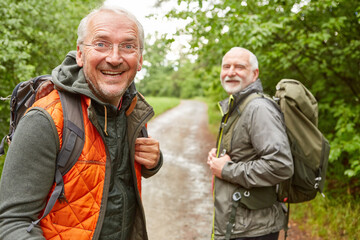 Elderly man with male friend in background at forest