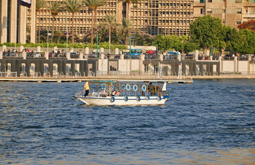 Egypt, Cairo - Boat in the Nile River under Bridge, Downtown Cairo.