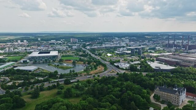 Drone shot of Wolfsburg city , Germany . It's known as the headquarters for Volkswagen and for the Autostadt, an automobile-themed park with a classic-car museum and driving track.