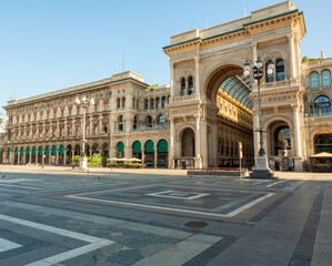 panorama of piazza del Duomo with the monumental entrance to the historic Galleria Vittorio Emanuele, an elegant meeting place and international center of luxury shopping  - obrazy, fototapety, plakaty