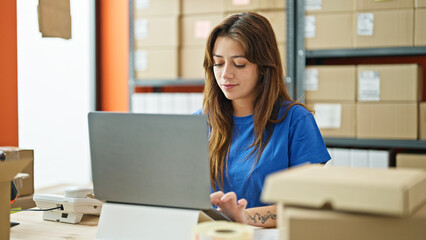 Young beautiful hispanic woman ecommerce business worker using laptop working at office