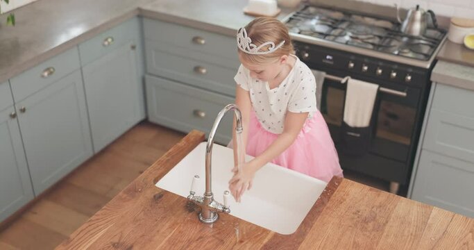 Girl, child washing and hands with soap in kitchen sink and learning about bacteria, cleaning and hygiene for safety or health. Teaching, self care and clean hand in water for germs, virus or dirt