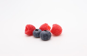 blueberries and raspberries on white background