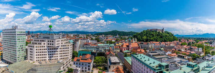 Obraz premium A panorama view over the rooftops towards the castle hill in Ljubljana, Slovenia in summertime