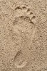 The texture of the sand about the footprints of hands and feet