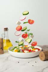 salad of fresh vegetables and greens with egg and feta cheese