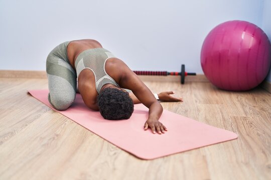 African american woman stretching back at sport center