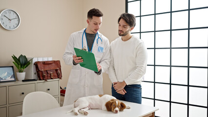 Two men having veterinarian consultation at veterinary clinic