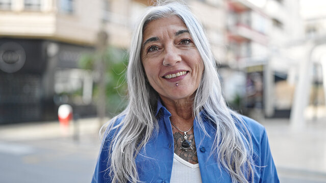 Middle age grey-haired woman smiling confident standing at street