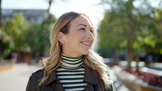Young beautiful hispanic woman smiling confident at park