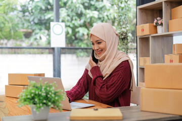 Beautiful Muslim woman selling online at home, business owner, business sme concepts