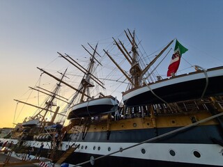 Fototapeta premium 2022.07.06 Palermo, Amerigo Vespucci training ship, evocative image of sailing ship from the quay at sunset