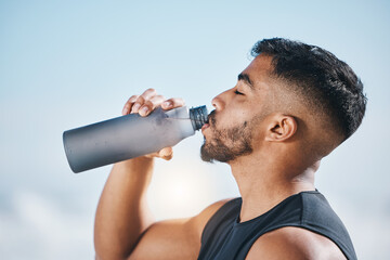 Fitness, man and drinking water outdoors after training, running or morning cardio routine. Thirst, hydration and Indian male runner with bottle drink after sports, workout and body performance - Powered by Adobe