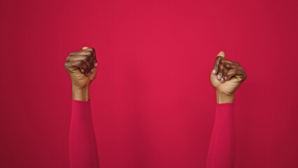 African american woman with thumbs up over isolated red background
