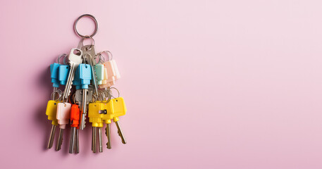 Creative concept of home protection, security system. A bunch of metal keys isolated on a pastel flat pink background with copy space for text. Generative AI.