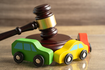 Hammer gavel judge with car vehicle accident, insurance coverage claim lawsuit court case.