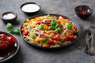 healthy pasta salad with zucchini sweet corn tomato and basil, vegetarian lunch