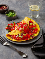 omelette with tomato, bell pepper onion chili and cheese. healthy breakfast