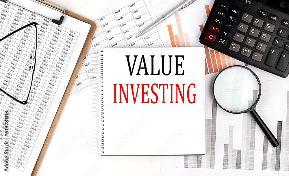Poster value investing text on notebook with clipboard and calculator on a chart background