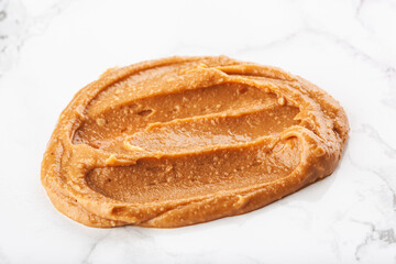 peanut butter swirl on white marble background