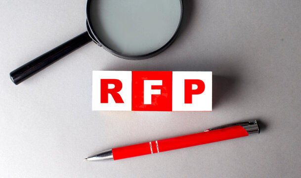 RFP word on wooden cubes with pen and magnifier
