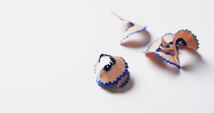 Close up of blue crayon shavings with copy space on white background, in slow motion