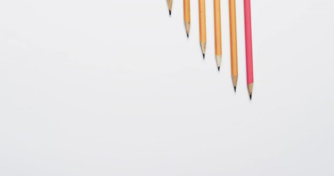 Close up of pencils arranged with copy space on white background, in slow motion