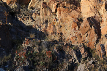 Layered rocks and hills. Surface of a natural stone brown colour