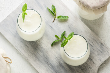 Glass cup of Turkish traditional drink ayran , kefir or buttermilk made from yogurt, healthy food - obrazy, fototapety, plakaty