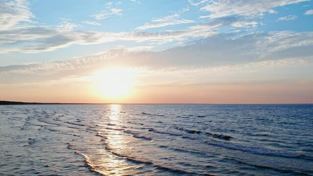 As the sun sets over the sea, the serene waves glisten with a golden hue, creating a soothing ambiance that embodies the concepts of rest, relaxation, and a well-deserved vacation