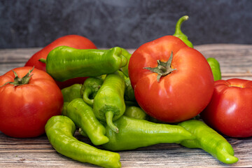 Various vegetables on a wooden table. Tomato , Green Pepper .