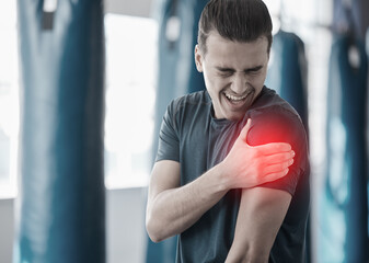 Hand, shoulder pain and the arm of a man in red highlight during a fitness workout. Healthcare,...