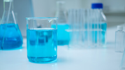 Glassware, beaker or test tube with blue substance or liquid. Concept of laboratory  background. Scientific analysis tools background. Chemistry and experiment glassware.