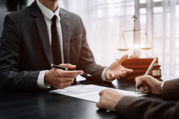 Business people and lawyers discussing contract papers sitting in the table at office in the morning. concepts of law, advice, legal services.