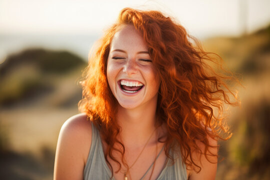 Portrait of a beautiful young red haired woman, her candid laughter radiating joy and a sense of vitality in a natural setting