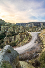 Fairy chimneys rock forms and sunset colors in the sky in Kula district of Manisa province