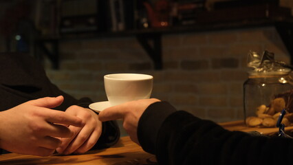 handing someone a coffee cup