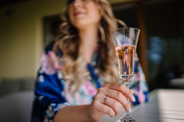 bride holding a glass of champagne 