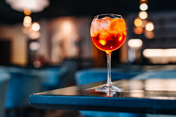 alcohol cocktail in a glass stands on a table in a bar or restaurant