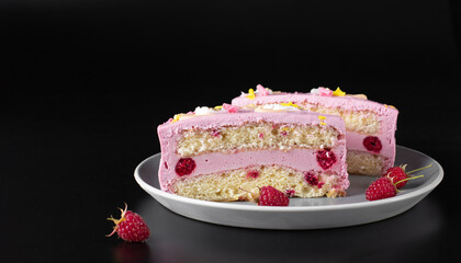 Sliced bento cake with raspberry filling on a gray plate on a black background